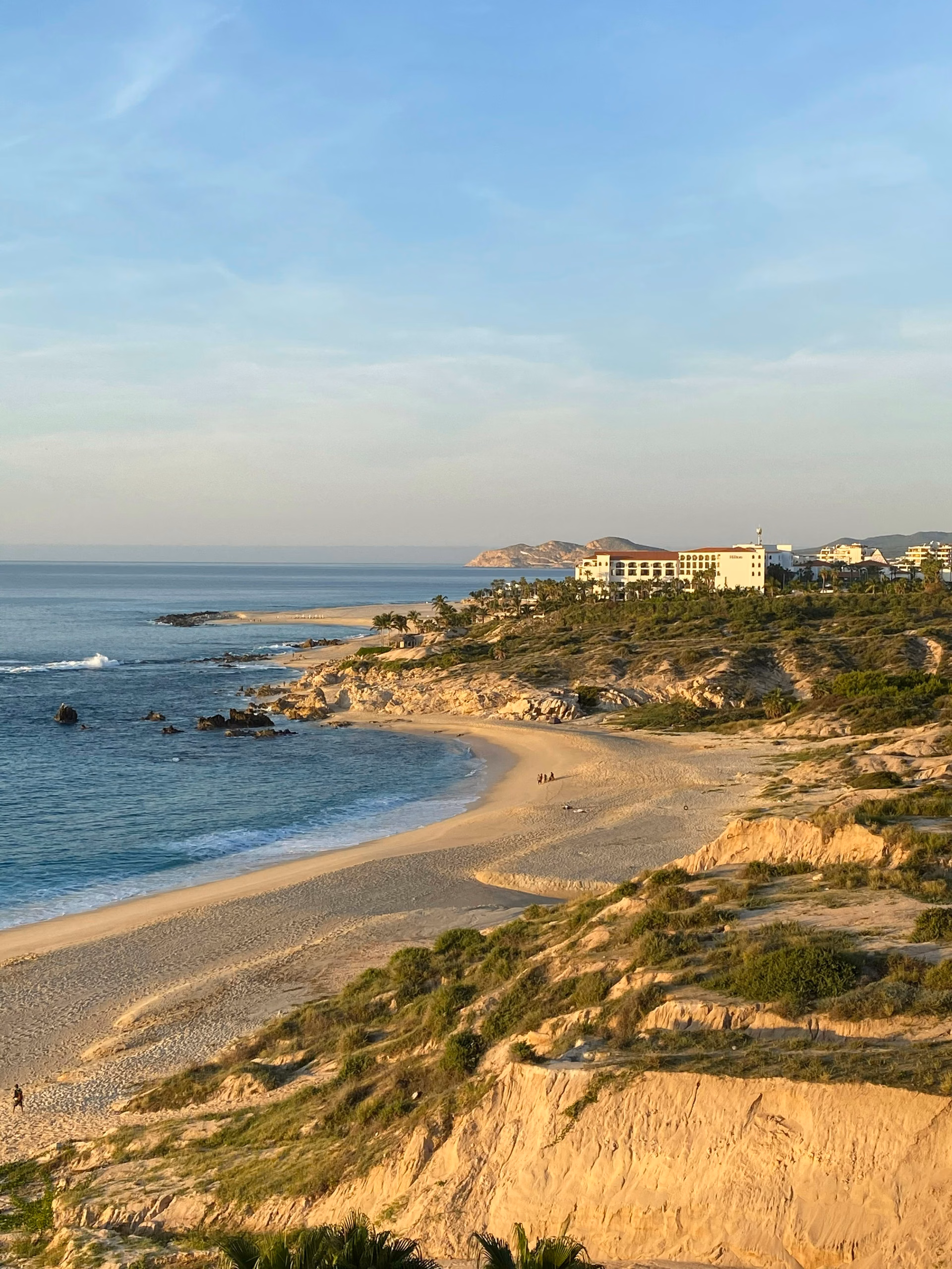 Aerial view of Los Cabos coastline with white buildings along a turquoise bay, Cabo Real setting, Cabo Corridor, Los Cabos