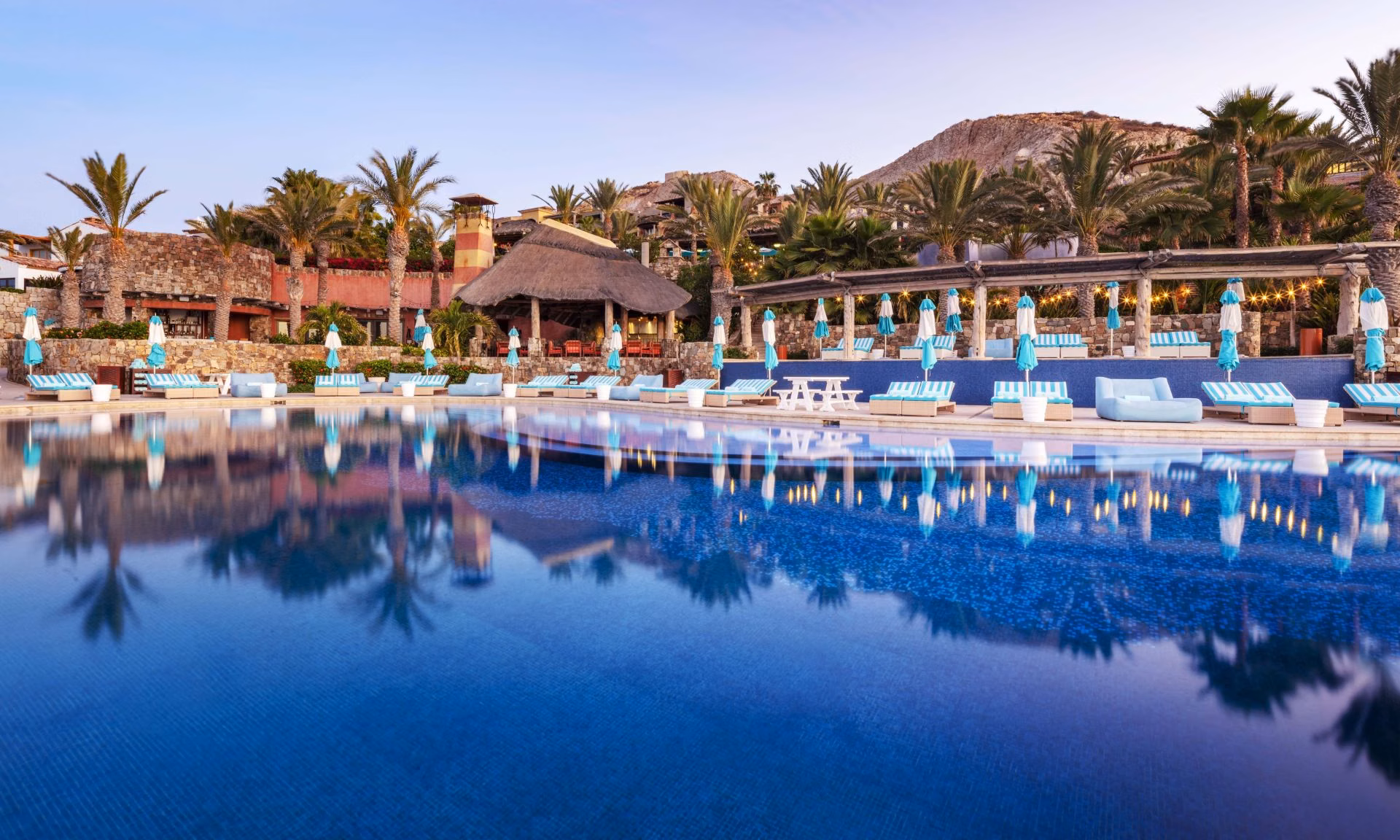 Golfers walking a sun-drenched fairway with ocean views, El Dorado Golf and Beach Club lifestyle, Los Cabos